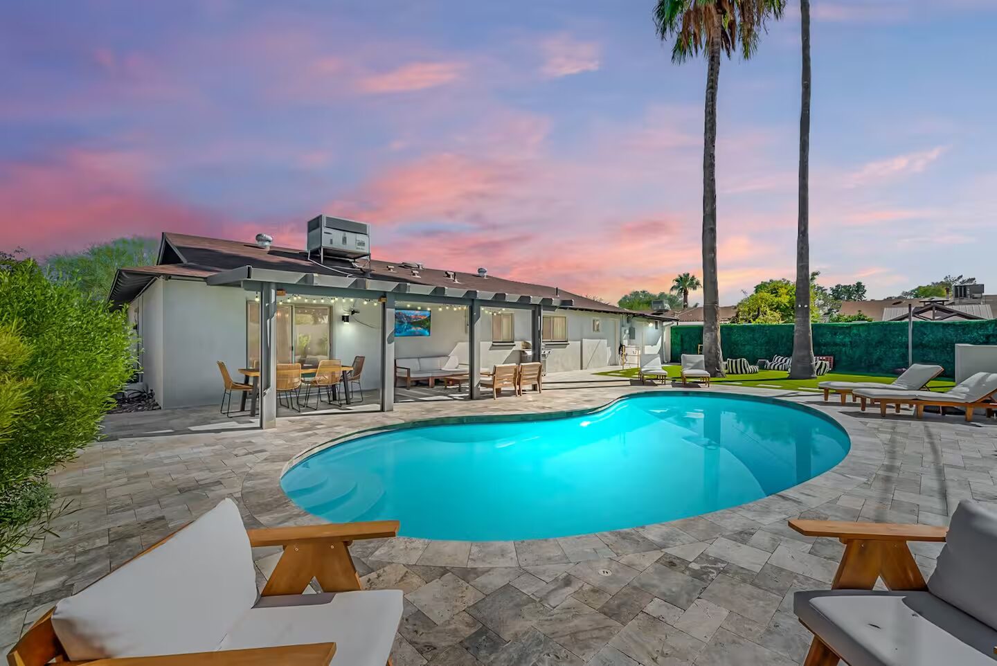 The private pool and turf yard at Vesper, a four-bedroom Scottsdale home with a casita, photographed at golden hour.